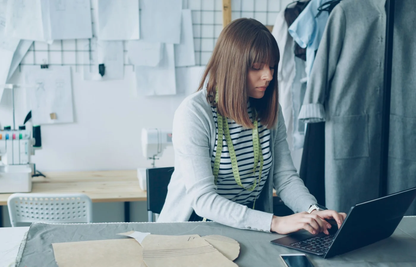 Small business owner working on laptop while managing local business visibility