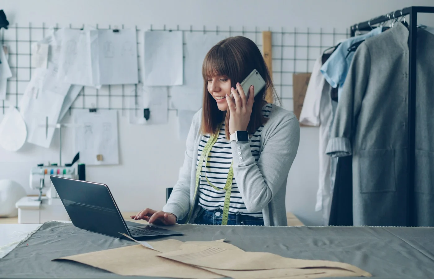 Small business owner using phone and laptop for local customer inquiries